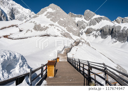 A wooden pathway on Jade Dragon Snow Mountain (or Mt.Yulong) in Yulong Naxi Autonomous County, Lijiang, in Yunnan province, China. 117674947