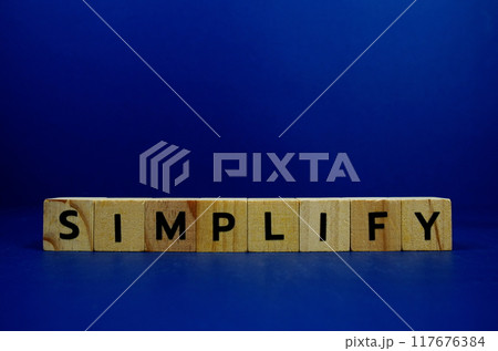 Simplify with wooden blocks alphabet letters and Magnifying glass on blue background 117676384