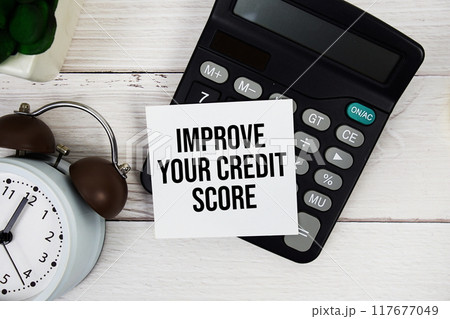 Improve Your Credit Score text message with calculate and alarm clock top view on wooden background Improve Your Credit Score text message with calculate and alarm clock top view on wooden background 117677049