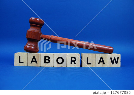 Labor Law alphabet letters with wooden blocks alphabet letters and Gavel on blue background 117677086