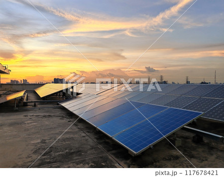 Manu solar panels install on the roof of office building at sunset Manu solar panels install on the roof of office building at sunset 117678421