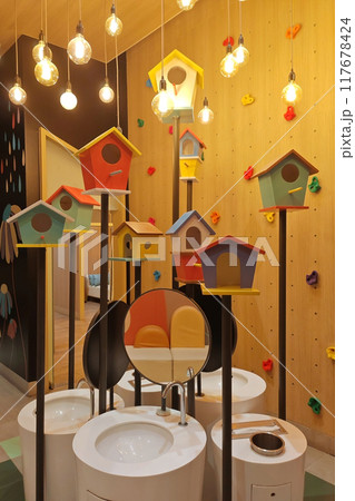 washbasins and colorful bird cages at cute toilet at modern building 117678424
