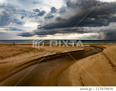 Landscape of dark rain clouds over ocean,stormy dark clouds over sand beach in Phuket island Thailand 117679656