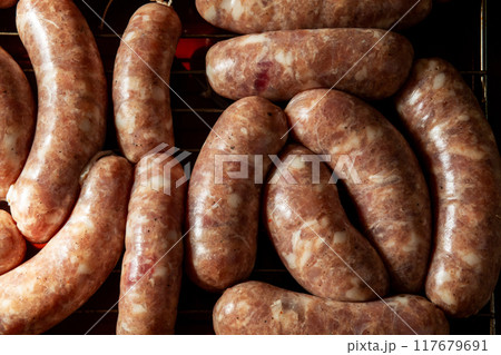 Concept of making homemade grilled sausages. 117679691