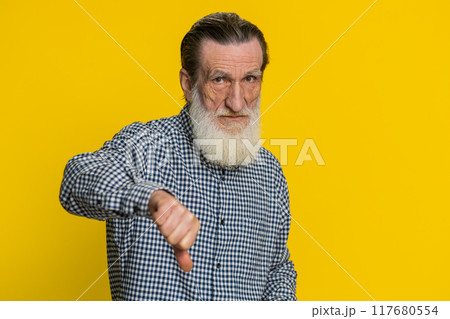 Upset grandfather man showing thumbs down gesture disapproval dissatisfied dislike negative feedback 117680554