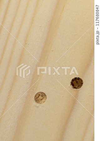metal drill bit and pine wood board during operation 117680847