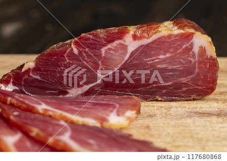 a piece of cured pork ham with thin layers of lard a piece of cured pork ham with thin layers of lard 117680868