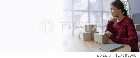 woman, online seller, efficiently manages customer orders and delivery through the e-commerce platform 117681949