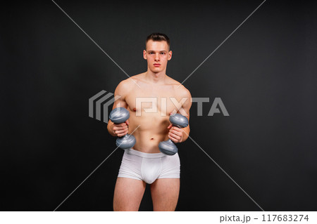 Dumbbells, fitness and man in studio for training, exercise or bodybuilding studio shot. Dumbbells, fitness and man in studio for training, exercise or bodybuilding studio shot. 117683274