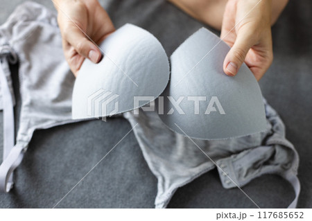 Woman holding the pads for bra. Woman holding the pads for bra. 117685652