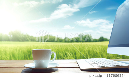 Computer on a desk with a white mug ,Computer with a image on screen of summer grass and clear blue skies, on a glass topped  , Generate AI Computer on a desk with a white mug ,Computer with a image on screen of summer grass and clear blue skies, on a glass topped  , Generate AI 117686334