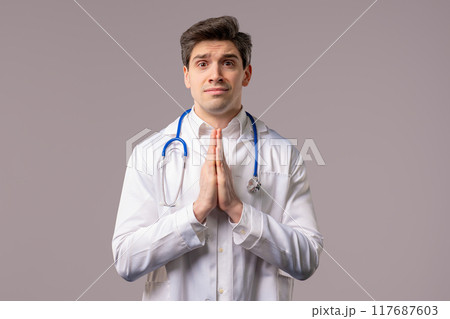 Mature 30s doctor man Praying, Begs Apologize, Guilty on White. Hopeful Prayer 117687603