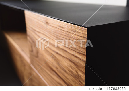 Closeup details of modern tv stand made from walnut and powder coated steed Closeup details of modern tv stand made from walnut and powder coated steed 117688053