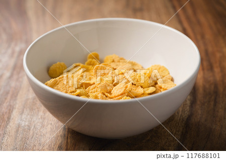 corn flakes in white bowl on table 117688101