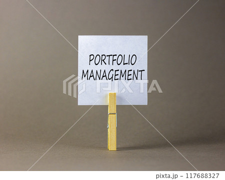 Portfolio management symbol. Concept words Portfolio management on beautiful white paper on wooden clothespin. Beautiful grey background. Business Portfolio management concept. Copy space. 117688327
