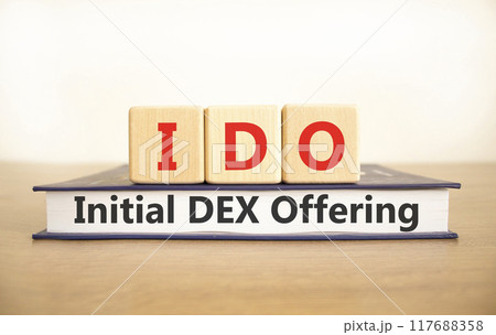 IDO initial DEX offering symbol. Concept words IDO initial DEX offering on beautiful wooden blocks and book. Beautiful white background. Business IDO initial DEX offering concept. Copy space. 117688358