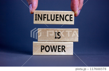 Influence is power symbol. Wooden blocks with words 'Influence is power'. Beautiful grey background, businessman hand. Business, influence is power concept, copy space. Influence is power symbol. Wooden blocks with words 'Influence is power'. Beautiful grey background, businessman hand. Business, influence is power concept, copy space. 117688378