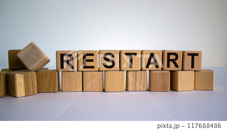 Concept word 'restart' on cubes on a beautiful wooden table. White background. Business concept. Concept word 'restart' on cubes on a beautiful wooden table. White background. Business concept. 117688486