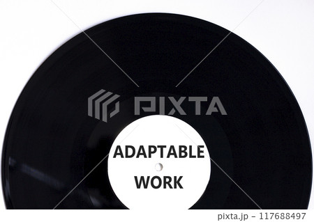 Adaptable work symbol. Concept words Adaptable work on beautiful white black vinyl disk. Beautiful white paper background. Business Adaptable work concept. Copy space. 117688497