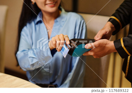 Woman Paying With Credit Card In The Restaurant Woman Paying With Credit Card In The Restaurant 117689322