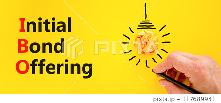IBO initial bond offering symbol. Concept words IBO initial bond offering on beautiful paper. Beautiful yellow background. Businessman hand. Business IBO initial bond offering concept. Copy space 117689931