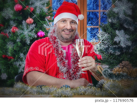 Capturing the Spirit of Christmas: Jolly Figure in Santa Hat Toasts Holidays with Warm Smile and Sparkling Wine. Capturing the Spirit of Christmas: Jolly Figure in Santa Hat Toasts Holidays with Warm Smile and Sparkling Wine. 117690576