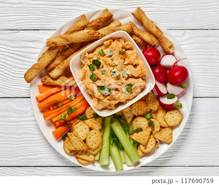 buffalo chicken dip with veggie and bread sticks 117690759