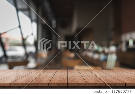 Empty wooden table top with lights bokeh on blur restaurant background. 117690777