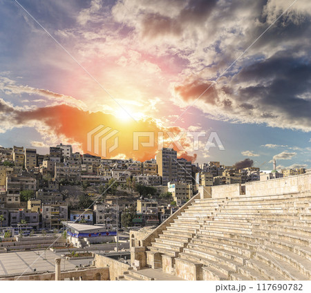 Roman Theatre in Amman, Jordan -- theatre was built the reign of Antonius Pius (138-161 CE), the large and steeply raked structure could seat about 6000 people. Against the sky with clouds Roman Theatre in Amman, Jordan -- theatre was built the reign of Antonius Pius (138-161 CE), the large and steeply raked structure could seat about 6000 people. Against the sky with clouds 117690782