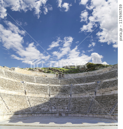 Roman Theatre in Amman, Jordan -- theatre was built the reign of Antonius Pius (138-161 CE), the large and steeply raked structure could seat about 6000 people. Against the sky with clouds 117690789