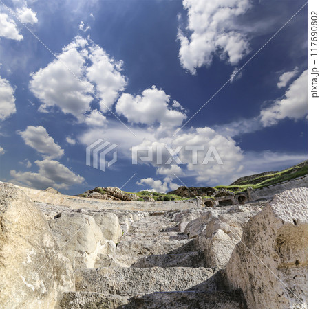 Roman Theatre in Amman, Jordan -- theatre was built the reign of Antonius Pius (138-161 CE), the large and steeply raked structure could seat about 6000 people. Against the sky with clouds Roman Theatre in Amman, Jordan -- theatre was built the reign of Antonius Pius (138-161 CE), the large and steeply raked structure could seat about 6000 people. Against the sky with clouds 117690802