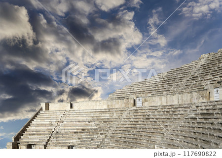 Roman Theatre in Amman, Jordan -- theatre was built the reign of Antonius Pius (138-161 CE), the large and steeply raked structure could seat about 6000 people. Against the sky with clouds 117690822