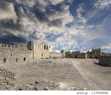 Ruins of Azraq Castle (Qasr al-Azraq) is a crusader castle (300AD),  central-eastern Jordan, 100 km east of Amman, Jordan. Against the background of a beautiful sky with clouds Ruins of Azraq Castle (Qasr al-Azraq) is a crusader castle (300AD),  central-eastern Jordan, 100 km east of Amman, Jordan. Against the background of a beautiful sky with clouds 117690866