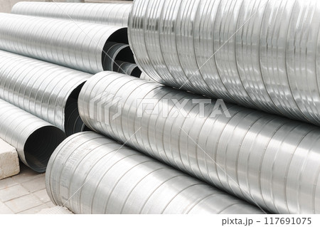 Metal profile pipes of different sizes are located in the warehouse of metal products. 117691075