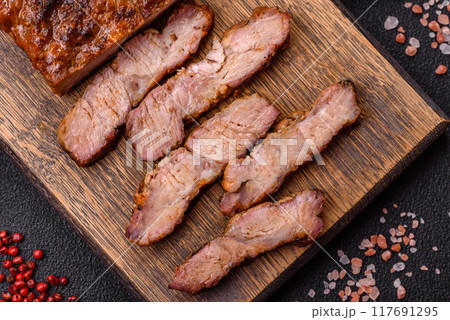 Fresh juicy delicious beef steak on a dark background Fresh juicy delicious beef steak on a dark background 117691295