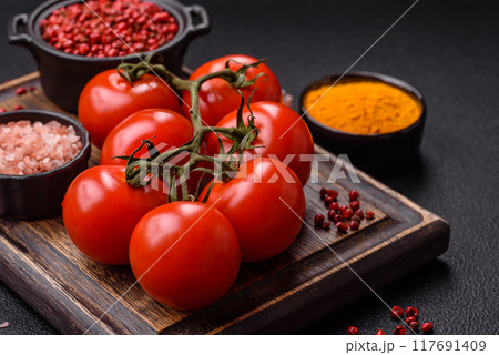 Juicy ripe red cherry tomatoes on a branch 117691409