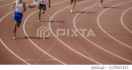 start group of athletes sprint race at stadium, athletics competition 117691421