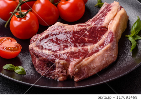 Fresh, raw beef steak with salt, spices and herbs 117691469