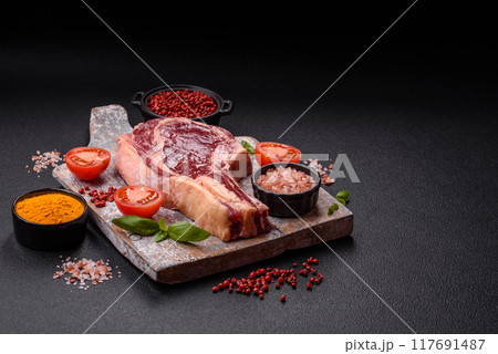 Fresh, raw beef steak with salt, spices and herbs Fresh, raw beef steak with salt, spices and herbs 117691487