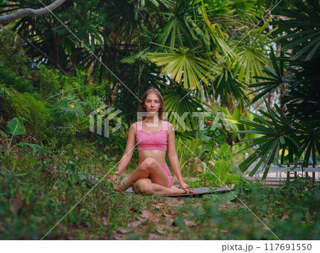 Beautiful woman practices yoga in Crabi, Thailand 117691550
