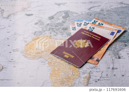 Conceptual background for travel with passport, magnifying glass, world map and money 117691606