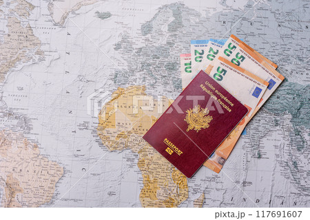 Conceptual background for travel with passport, magnifying glass, world map and money Conceptual background for travel with passport, magnifying glass, world map and money 117691607