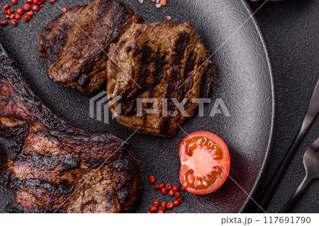 Juicy grilled beef tomahawk steak with salt, spices and herbs Juicy grilled beef tomahawk steak with salt, spices and herbs 117691790