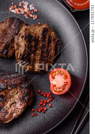 Juicy grilled beef tomahawk steak with salt, spices and herbs Juicy grilled beef tomahawk steak with salt, spices and herbs 117691791