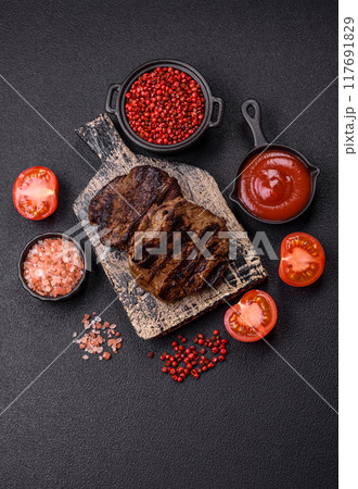 Fresh juicy delicious beef steak on a dark background 117691829