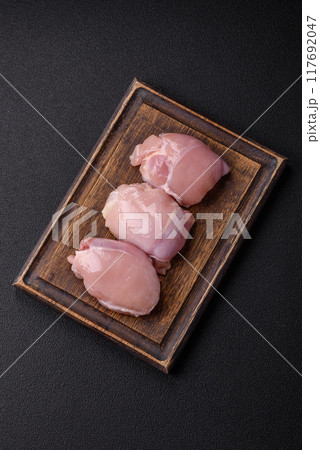 Fresh chicken fillet on a dark concrete table with spices and herbs 117692047