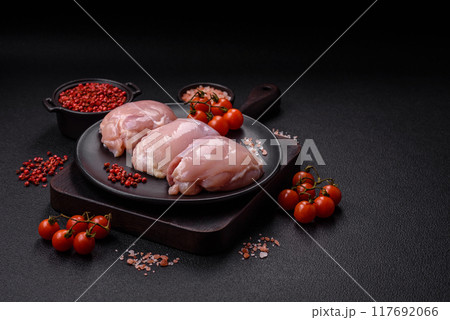 Fresh chicken fillet on a dark concrete table with spices and herbs 117692066