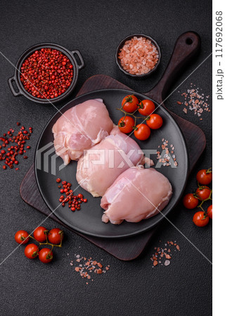 Fresh chicken fillet on a dark concrete table with spices and herbs 117692068