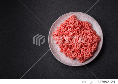 Fresh raw ground beef with salt and spices 117692124