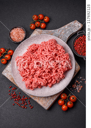 Fresh raw ground beef with salt and spices Fresh raw ground beef with salt and spices 117692128